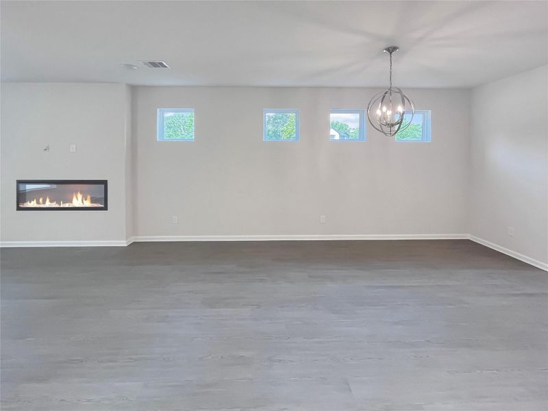 The Robin II- Family Room with Linear Electric Fireplace into the Dining. Sample image to be used for example only.