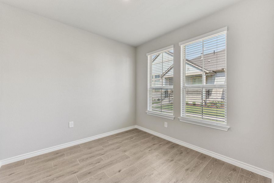 Empty room featuring baseboards and wood tiled floors Empty room featuring baseboards and wood tiled floors
