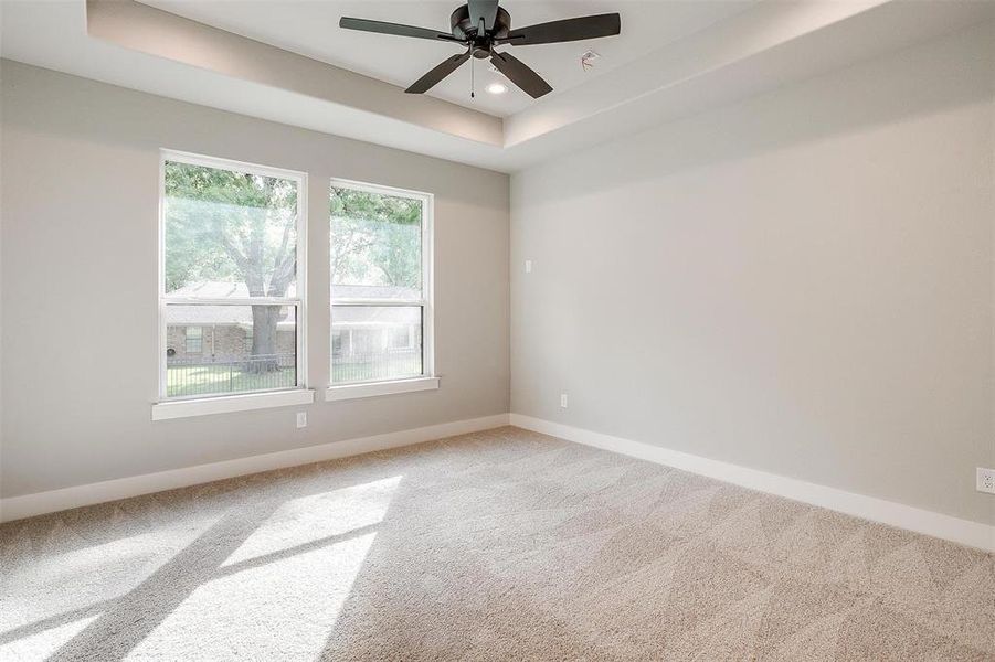 Unfurnished room featuring recessed lighting, a tray ceiling, a ceiling fan, light carpet, and baseboards Unfurnished room featuring recessed lighting, a tray ceiling, a ceiling fan, light carpet, and baseboards