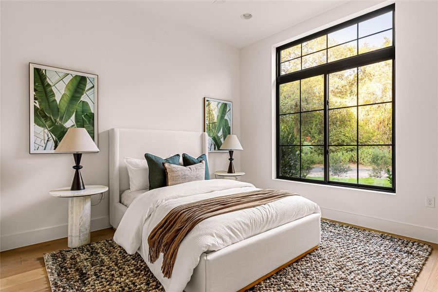 A quiet study provides a bright, productive space with polished hardwood flooring and natural light.