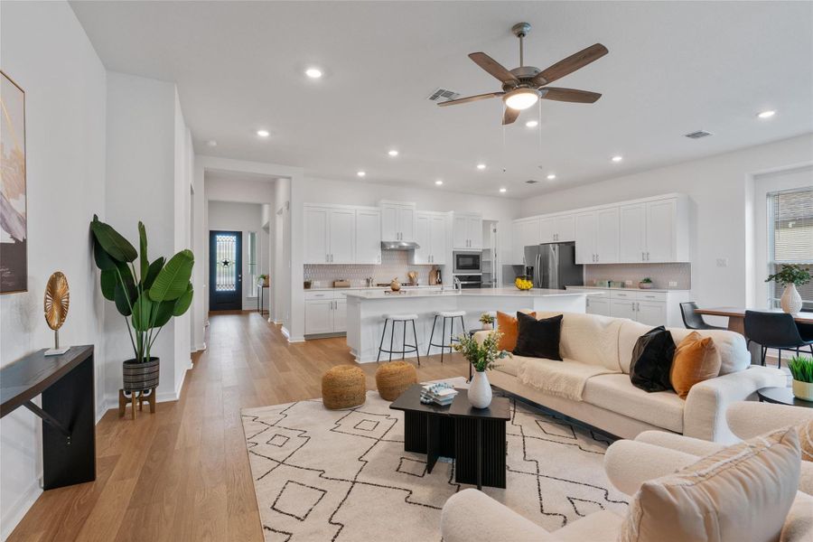 An open-concept living area flows seamlessly into a well-appointed kitchen, ideal for modern entertaining.