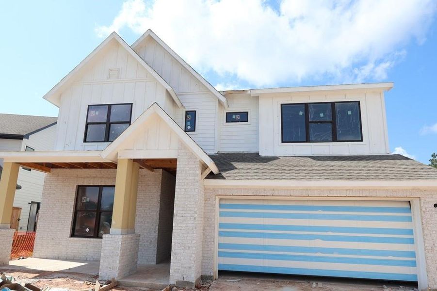 Front exterior of a new home in Kresston, Magnolia, TX, highlighting curb appeal (Image 2).