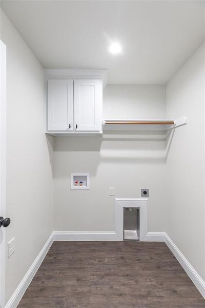 Laundry room featuring wood-finish flooring, white cabinetry with dark hardware, a built-in hanging rod, and recessed lighting