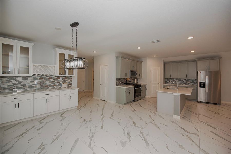 A view of the formal dining area open to the kitchen. Amazing space for those who love to entertain. Cabinetry is perfect for showcasing your favorite stemware and china and there is even a wine rack. A view of the formal dining area open to the kitchen. Amazing space for those who love to entertain. Cabinetry is perfect for showcasing your favorite stemware and china and there is even a wine rack.