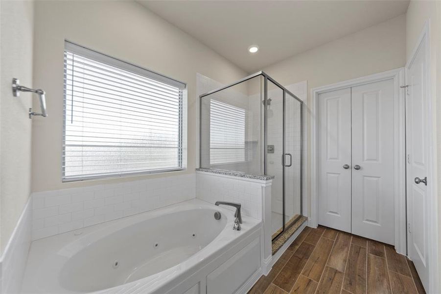 Full bathroom featuring a shower stall, a whirlpool tub, wood tiled floors, and recessed lighting