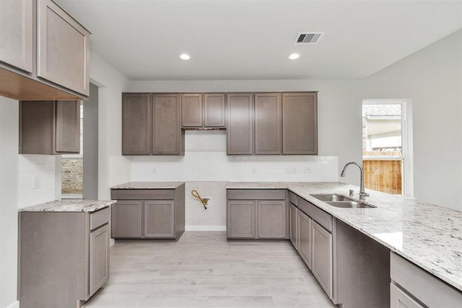 This generously spacious kitchen is a dream realized! Sample photo of completed home with similar floor plan. Actual colors and selections may vary.