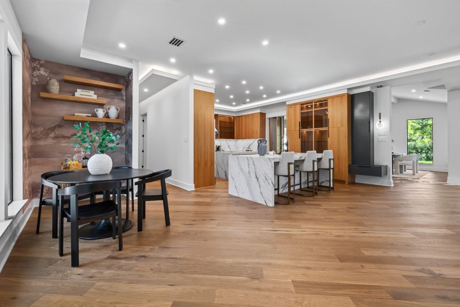Intimate breakfast nook area surrounded by natural light and views of the landscaped grounds.