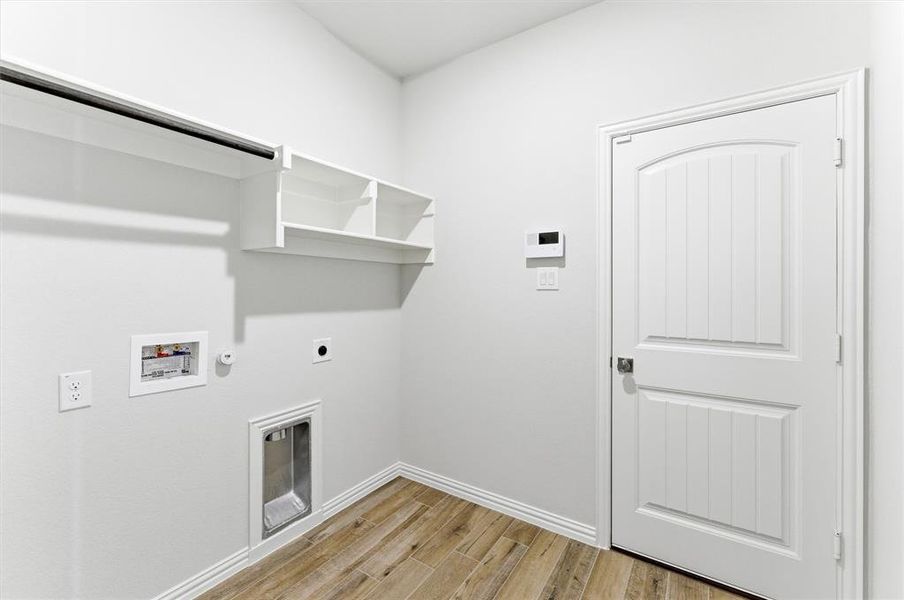 Laundry area featuring light wood-type flooring, hookup for a gas dryer, washer hookup, and electric dryer hookup