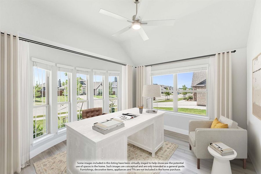 Home office with vaulted ceiling, ceiling fan, large windows, and white desk with seating area