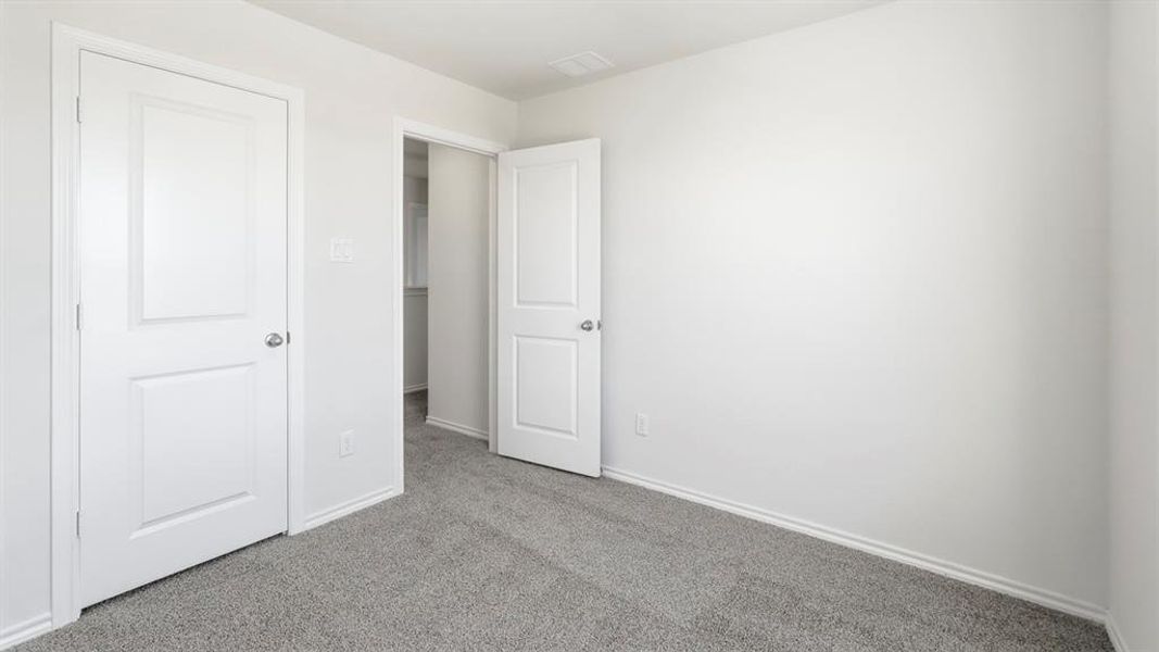 Unfurnished bedroom with carpet floors and baseboards