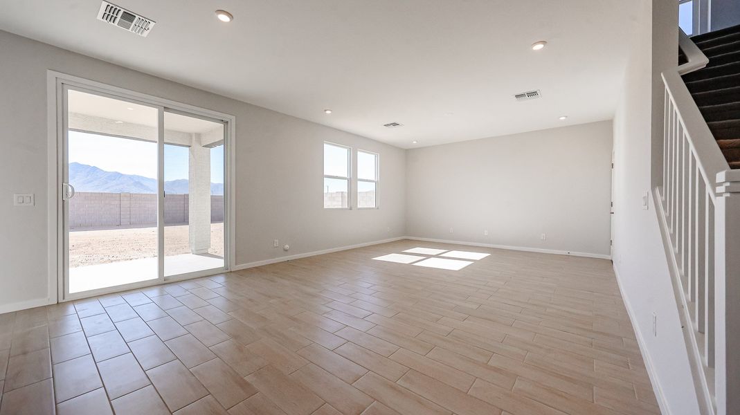 A room with a wood floor and a wood floor with a window.