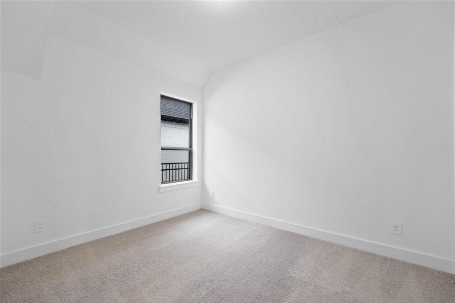 This inviting secondary bedroom combines comfort and modern elegance, featuring a soft neutral color palette, large window with an abundant of natural light streaming through and an ample sized closet.