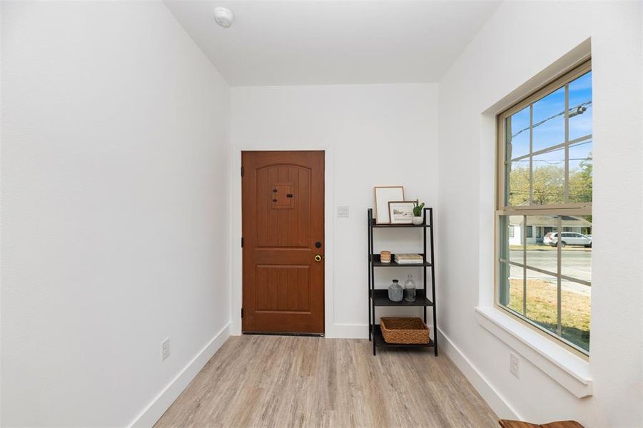 Foyer with light wood-style floors and baseboards Foyer with light wood-style floors and baseboards