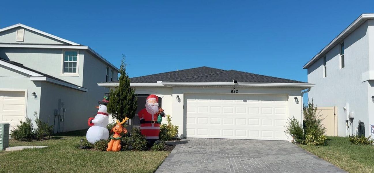 Front exterior of a new home in , Palm Bay, FL, highlighting curb appeal (Image 2). Front exterior of a new home in , Palm Bay, FL, highlighting curb appeal (Image 2).