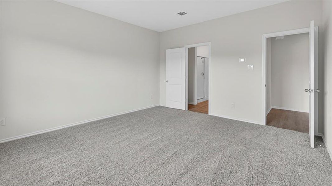 Spacious room featuring light gray carpet, neutral wall paint, and white trim Spacious room featuring light gray carpet, neutral wall paint, and white trim