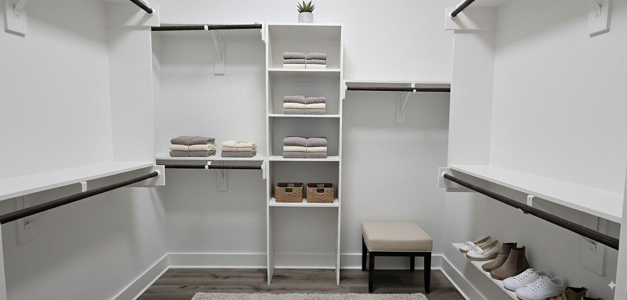 Primary closet with abundant storage and built in shelving. Primary closet with abundant storage and built in shelving.