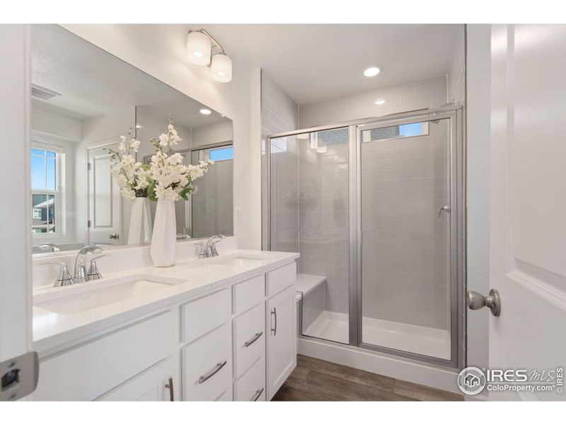 Primary Attached Bath with Undermount Dual Sinks and Walk-in Shower with Bench Seating