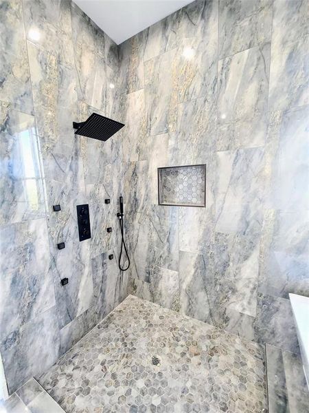 Bathroom featuring tiled shower