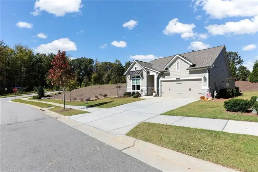 Front exterior of a new home in The Retreat at Sterling on the Lake 48', Flowery Branch, GA, highlighting curb appeal (Image 23).