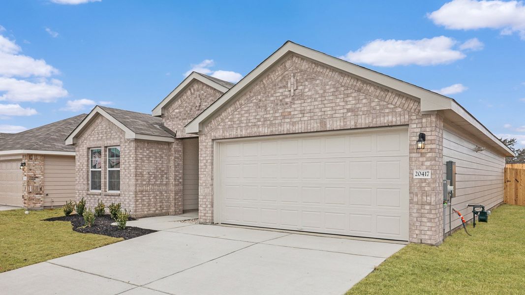 Front exterior of a new home in Carillon, Manor, TX, highlighting curb appeal (Image 17).