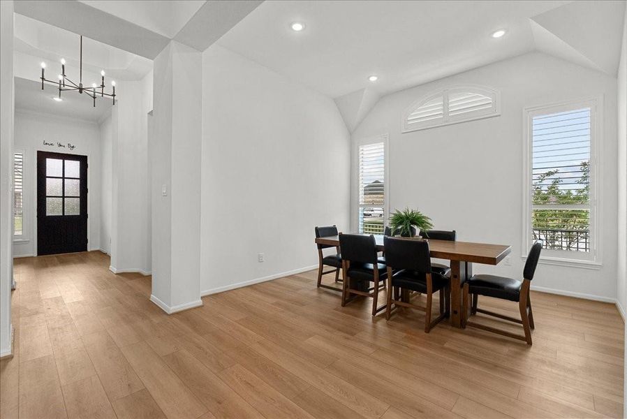 Formal dining room with serene water views, creating the perfect setting for entertaining and gatherings.