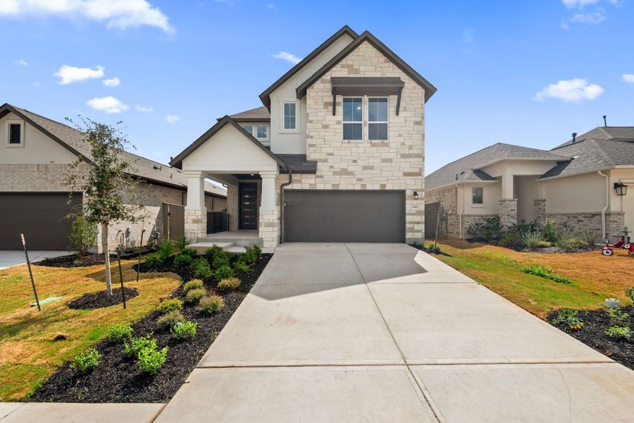 Front exterior of a new home in Flora, Hutto, TX, highlighting curb appeal (Image 22).