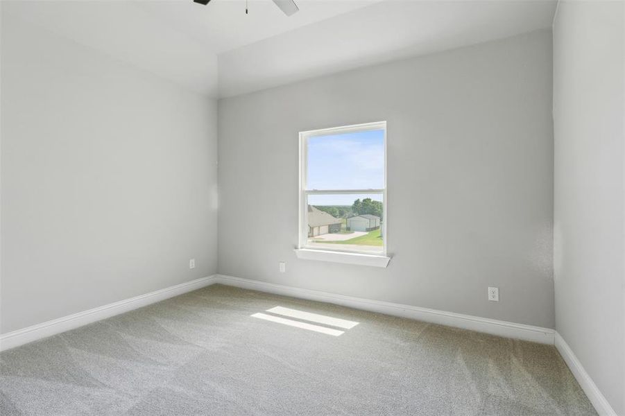 Empty room featuring carpet floors and ceiling fan