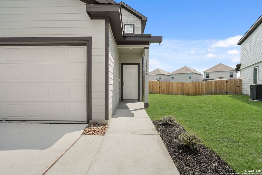 Front exterior of a new home in Melissa Ranch, San Antonio, TX, highlighting curb appeal (Image 18). Front exterior of a new home in Melissa Ranch, San Antonio, TX, highlighting curb appeal (Image 18).