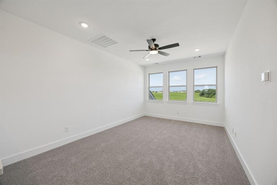 Spare room with light colored carpet, recessed lighting, and a water view Spare room with light colored carpet, recessed lighting, and a water view