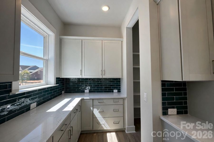 Featuring a Unique Kitchen Layout with Lazy Susan + Drawers Dedicated to Pot & Pan Storage