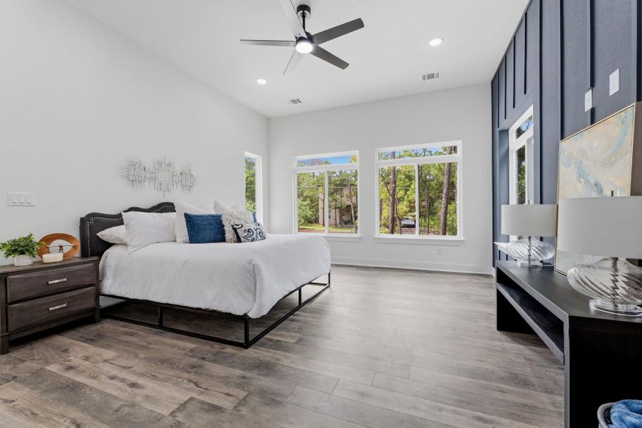 A spacious bedroom retreat boasts high ceilings and abundant natural light.