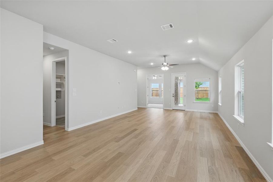 Unfurnished living room featuring light wood-type flooring, recessed lighting, ceiling fan, and vaulted ceiling Unfurnished living room featuring light wood-type flooring, recessed lighting, ceiling fan, and vaulted ceiling