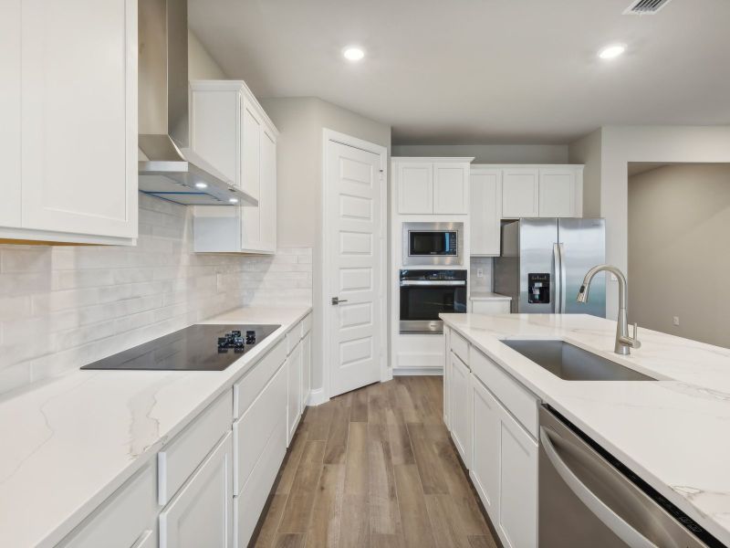 Kitchen in the Coral floorplan at 6398 NW Sweetwood Dr