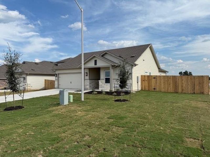 Front exterior of a new home in Grande Estates, Bertram, TX, highlighting curb appeal (Image 2). Front exterior of a new home in Grande Estates, Bertram, TX, highlighting curb appeal (Image 2).