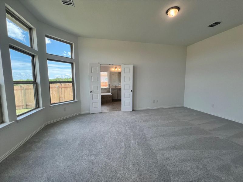 Unfurnished bedroom with carpet and ensuite bath Unfurnished bedroom with carpet and ensuite bath