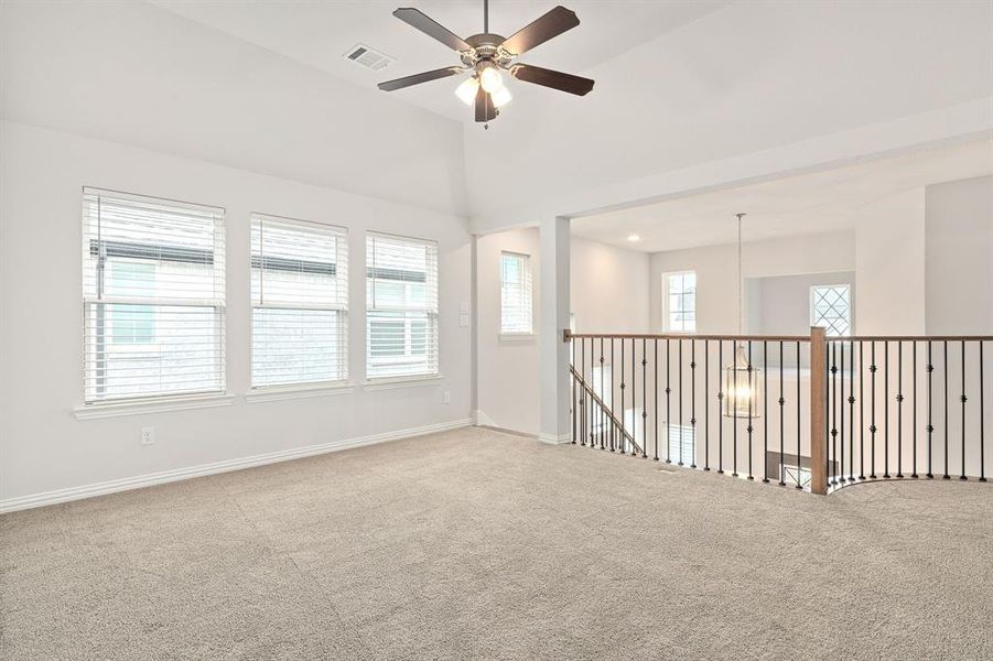 Game room with tons of natural light and ceiling fan