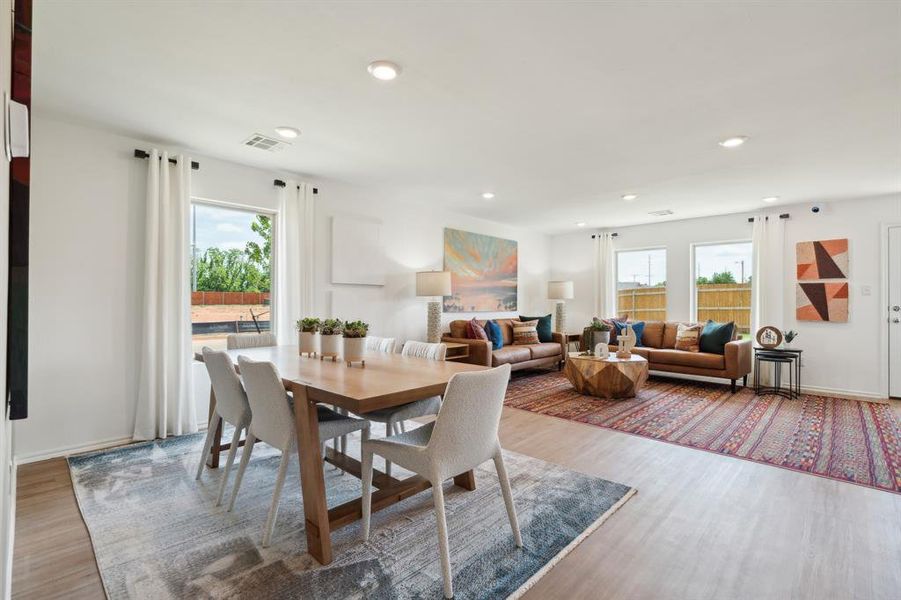 Dining area featuring wood-type flooring and a healthy amount of sunlight