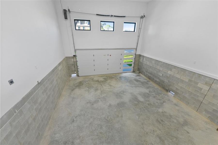 The oversized two car garage has ample room in length and height. Easily adapted to hold four cars with a lift or add loft storage above. There is a space reserved for a lift to the main living floor from the garage. The builder has thoughtfully run wiring for electric vehicles.