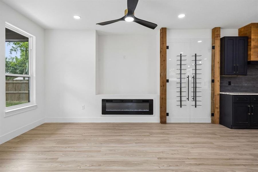 Open-concept living space with wood-finish flooring Open-concept living space with wood-finish flooring