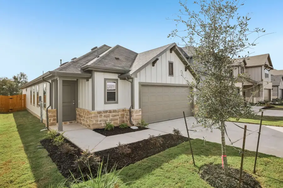 Front exterior of a new home in Trinity Ranch, Elgin, TX, highlighting curb appeal (Image 22).