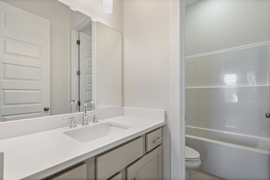 Full bathroom featuring vanity and toilet