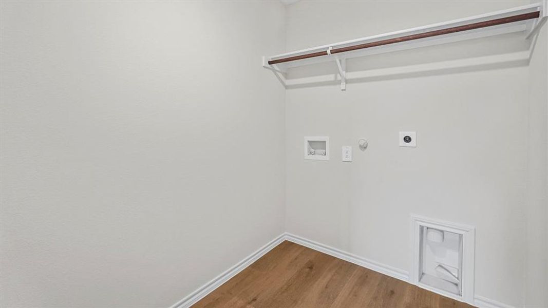 Laundry area with hookup for a gas dryer, wood finished floors, washer hookup, and hookup for an electric dryer