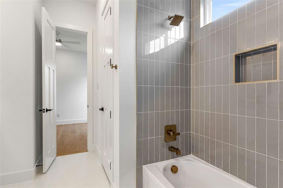 Full bath with shower / bath combination and light tile patterned flooring