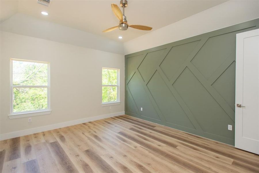 Unfurnished room with ceiling fan and light hardwood / wood-style floors