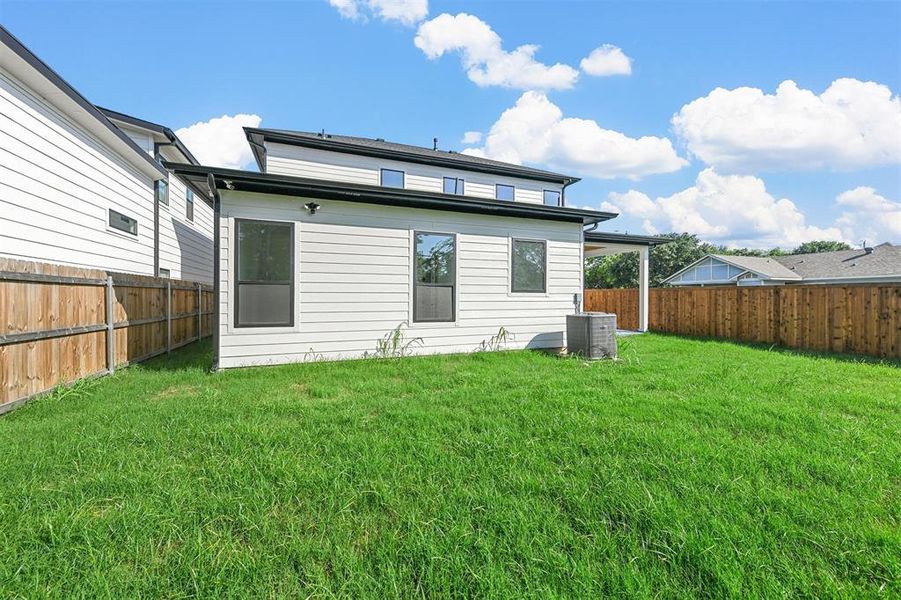 Rear view of property featuring a lawn