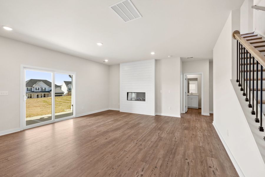 A large empty room with a wood floor.