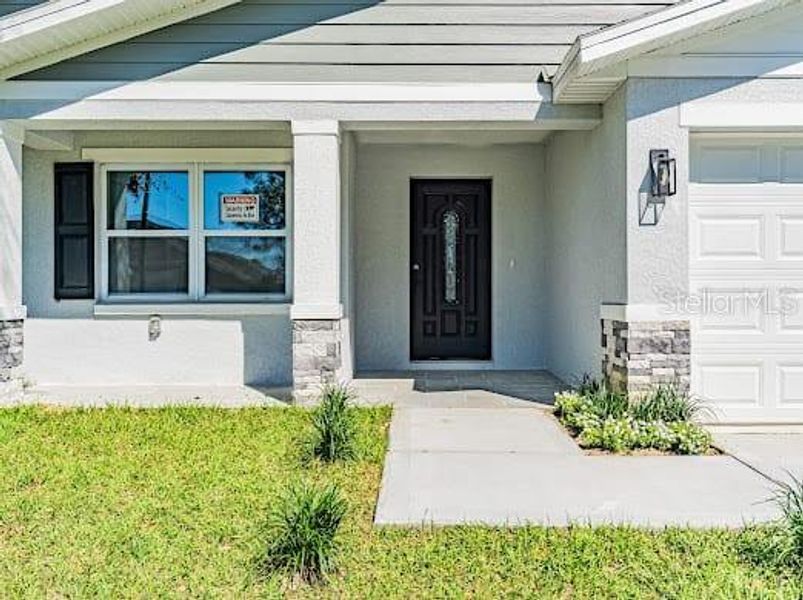 Front exterior of a new home in , Kissimmee, FL, highlighting curb appeal (Image 13). Front exterior of a new home in , Kissimmee, FL, highlighting curb appeal (Image 13).