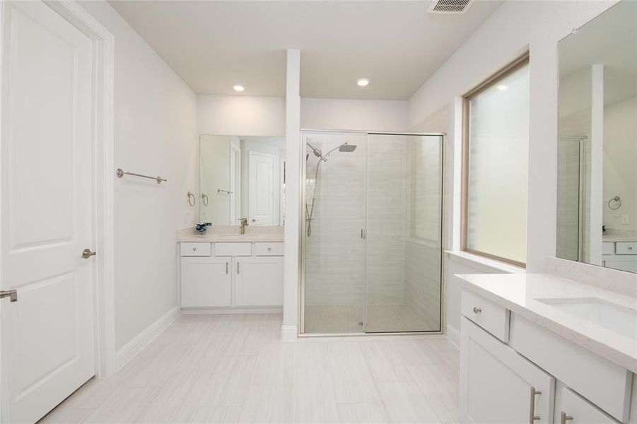 Separate his-and-her vanities provide convenience and personal space, while the expansive layout creates a luxurious owner's retreat experience. Separate his-and-her vanities provide convenience and personal space, while the expansive layout creates a luxurious owner's retreat experience.
