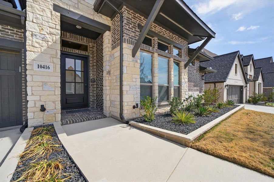 Welcoming front entry with striking stone and brick exterior Welcoming front entry with striking stone and brick exterior
