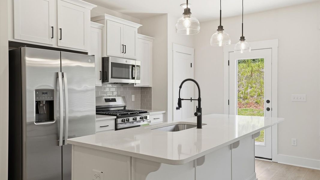 Notable kitchen space with elegant pendant lighting and a center island perfect for entertaining at Marion Square Notable kitchen space with elegant pendant lighting and a center island perfect for entertaining at Marion Square
